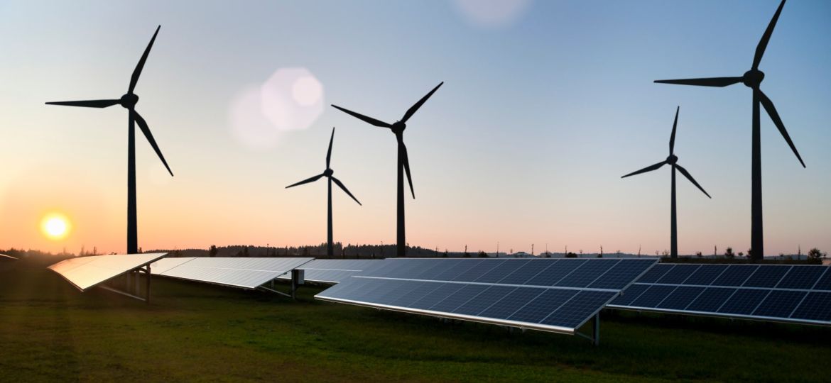 Wind turbines and solar panels in field